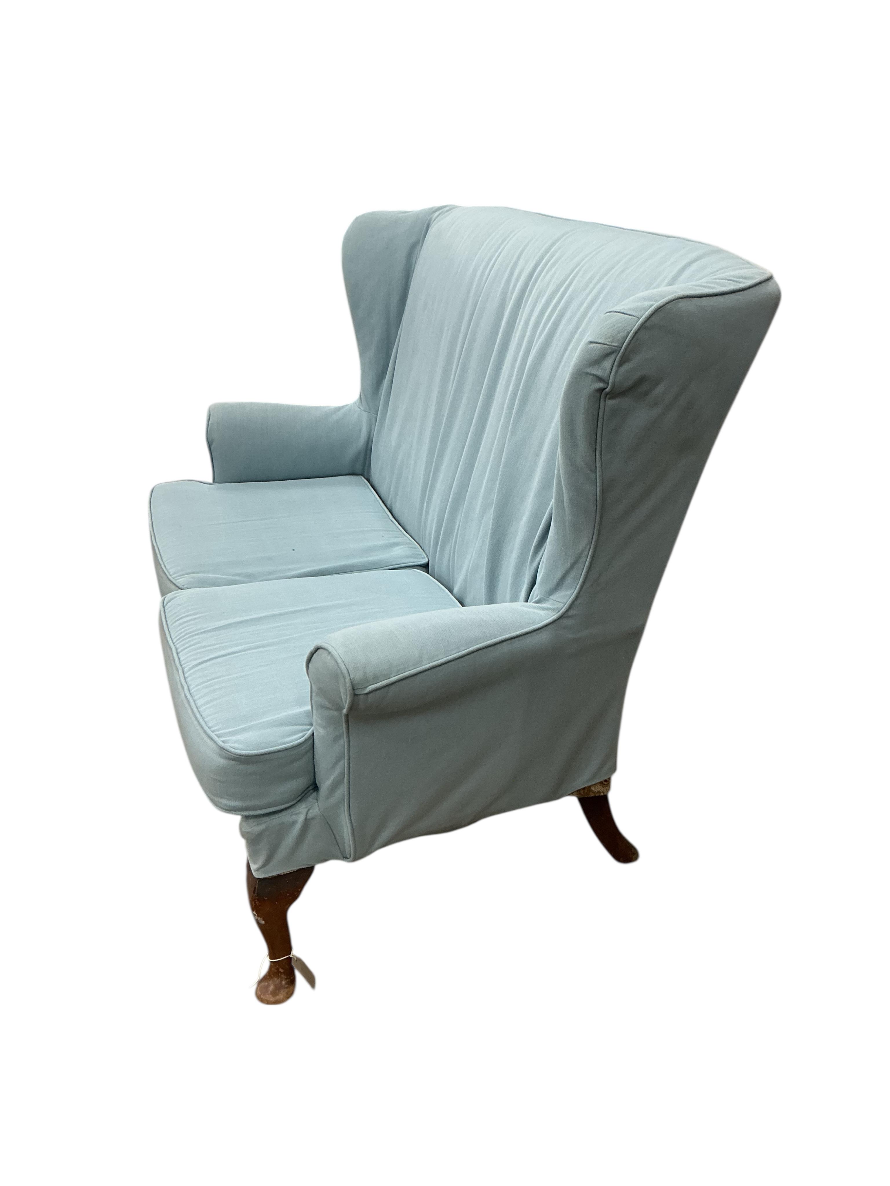 A Parker Knoll wing back upholstered two seater settee, width 136cm, depth 70cm, height 96cm